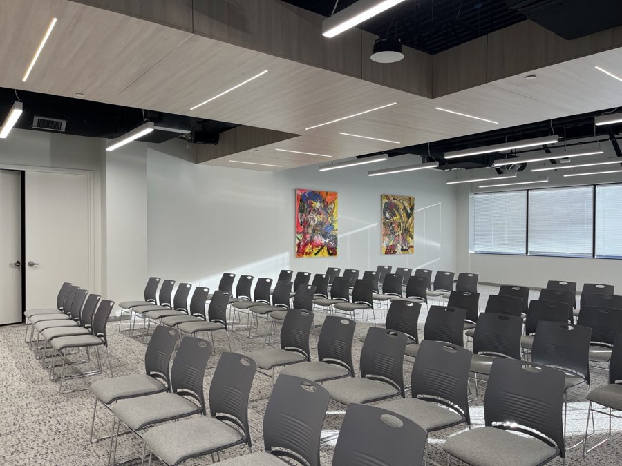 SevaSpaces events center set theater-style, original artwork on the walls